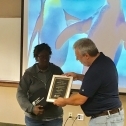 Cacelia "Sam" Bryson (left) receives a plaque from Jim Spichiger 3765